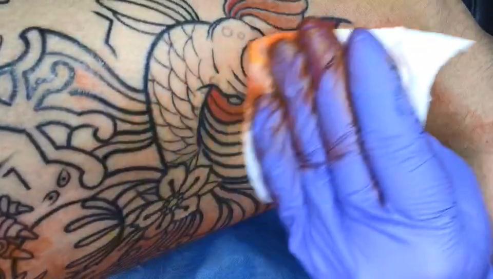 腰侧传统金鱼纹身图案纹身师上色打雾视频